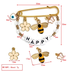 Detail view of Evil Eye brooch with Happy beads, bee and flower charms and size labels