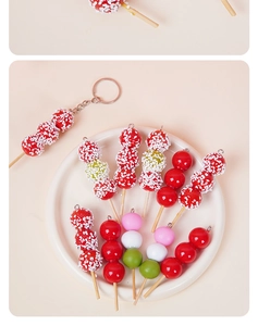Detailed view of miniature candied haws and tricolor dango charms in a ceramic plate