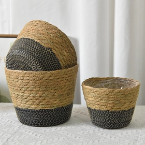 Close-up of seagrass planters with waterproof liners and detailed natural woven texture