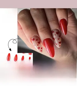Close-up of Valentine heart press-on nails with red almond shape and glossy finish
