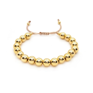 Adjustable golden metal bead bracelet with brown woven cord in minimalist retro style