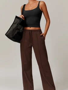 Brown drawstring straight-leg yoga pants paired with a black camisole top on a model
