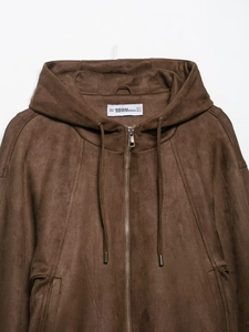 Detailed view of brown faux suede hooded jacket texture with zipper and size label