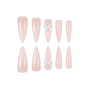 Long almond press-on nails in nude pink finish with 3D white bow tie accents