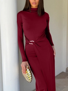 Detail of burgundy long sleeve dress featuring waist ruching and a silver metal ring buckle