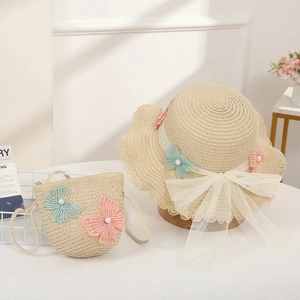 Detail of children's straw hat and bag set with mesh bow and butterfly lace patches