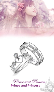 Detail of silver crown couple rings with heart-shaped hollow and sparkling zircon accents