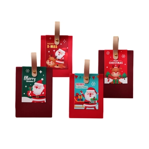 Christmas gift boxes with leather handles and festive Santa motifs on white background