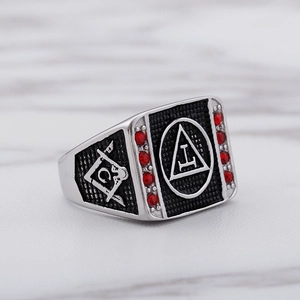 Detail of silver masonic ring with red rhinestones and black compass emblem