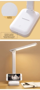 Detail of LED desk lamp with white leather texture base and built-in phone holder stand