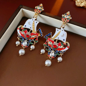 Detailed macro shot of vintage sailboat earrings with pearls and colorful enamel crystals