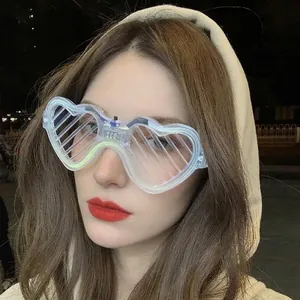 Pink LED heart-shaped shutter glasses worn by a female model at night party