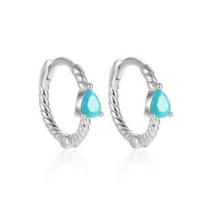 Macro detail of S925 silver hoop earrings with twisted texture and teardrop turquoise stone