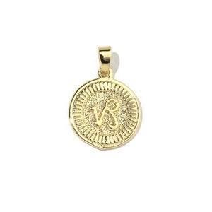 Detailed close-up of 18k gold-plated Capricorn zodiac pendant with sun-ray texture edges