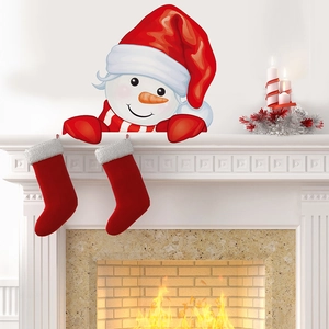 Cozy scene showing Christmas snowman wall stickers applied above a white fireplace mantel