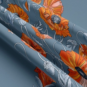 Close-up of floral wall tapestry with orange poppies on a muted blue soft fabric