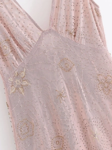 Macro detail of pink tulle midi dress featuring delicate sequins and beadwork embroidery