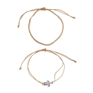 Detail of hand-woven turtle anklets with vintage silver charms and adjustable hemp ropes