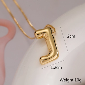Macro shot of gold letter J pendant with dimensions 2cm by 1.2cm and weight 10g