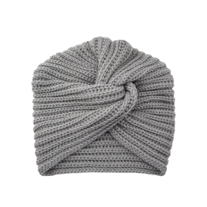 Close-up of grey knit turban hat with cross knot design and thick woven texture