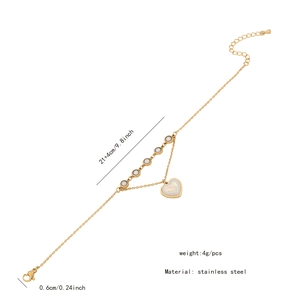 Detail of gold double-layered stainless steel anklet with heart pendant and beads