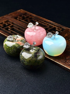 Detailed view of apple crystal ornaments with rhinestone metal leaves on wooden base