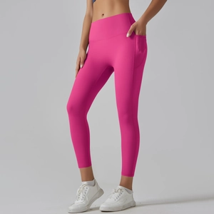 Detail of high waisted yoga pants in rose red with side pockets for fitness use