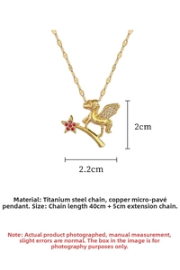 Detailed view of gold Pegasus pendant with cubic zirconia wings and five red gemstones