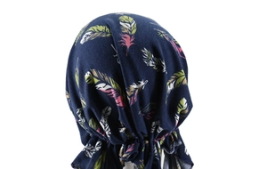 Detail showing elastic pleats and colorful feather print on navy blue turban headscarf