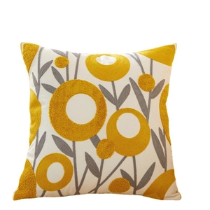Embroidered cotton throw pillow with yellow and grey abstract floral patterns on cream fabric