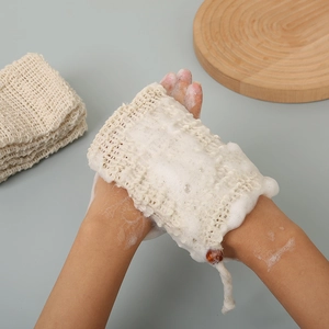 Action shot showing natural sisal soap bag creating rich foam for gentle exfoliation