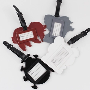 Close-up of colorful cartoon luggage tags with address card slots and black straps