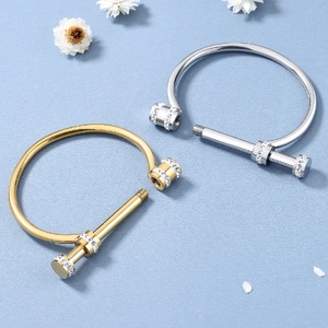 Luxurious gold and silver titanium steel horseshoe bracelets with pavé set crystals