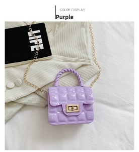 Detail of purple quilted jelly bag with gold twist lock and woven top handle