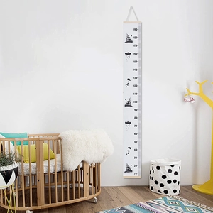 Nordic children's growth chart with wood frame and cartoon space design in kids room