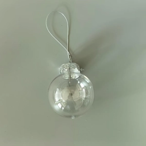 Detail of clear 6cm plastic ball ornament with silver cap and braided hanging string