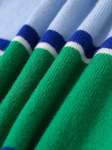 Detailed macro view of the soft multi-color striped knit fabric texture and fine stitch pattern