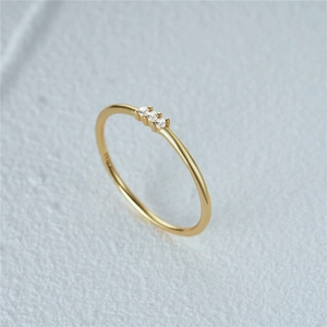 Macro shot of 925 sterling silver gold ring showing three inset diamonds and hallmark