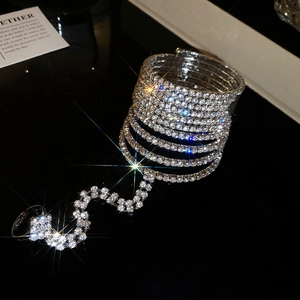 Macro detail of silver multi-layered rhinestone bracelet with finger ring attachment