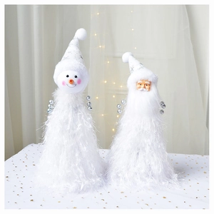 Detail of plush Santa and Snowman tabletop ornaments with white tinsel and star patterns