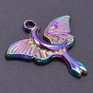 Macro shot of iridescent rainbow butterfly moon pendant in stainless steel for DIY jewelry