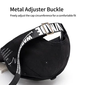 Black cotton baseball cap with adjustable metal buckle and long decorative logo strap