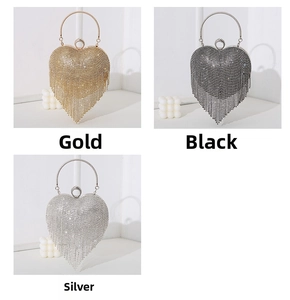 Three heart-shaped evening clutch bags in gold, silver, and black with rhinestone tassels