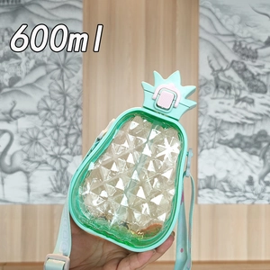 Detail showing the 600ml pineapple shaped water bottle in mint green with adjustable strap