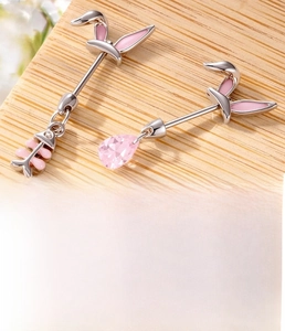Detail of bunny cartilage earrings with pink fishbone and teardrop crystal charms
