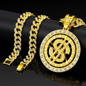 Macro shot of gold hip hop pendant necklace with dollar symbol and sparkling rhinestones