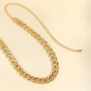 Close-up of golden Cuban link chain with adjustable extension and metallic shine