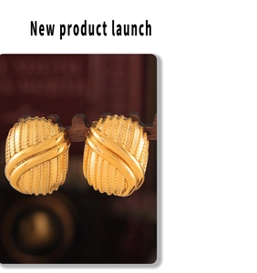 Macro detail of 18K gold-plated titanium steel earrings with vintage vertical texture