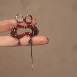 Gothic crescent moon earrings with red gemstone and asymmetrical metal chain tassels