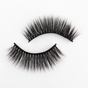 Detail of 3D faux mink eyelashes with thick natural black fibers on a white background